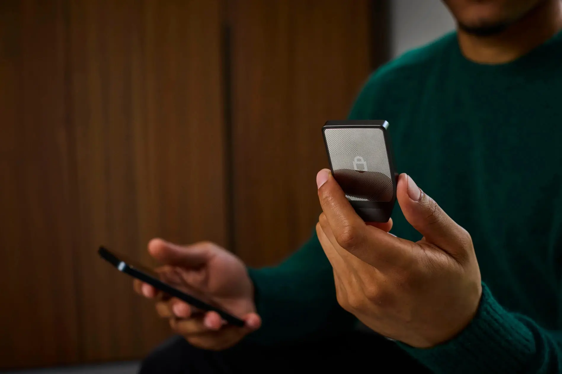 Trezor Safe 7 Review (2026): The New King of Cold Storage? 4 A user holding the Trezor Safe 7 hardware wallet featuring a textured lock design while connecting t