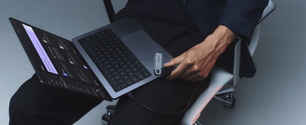 Ledger Nano S hardware wallet connected to a laptop for secure cryptocurrency self custody and transaction signing