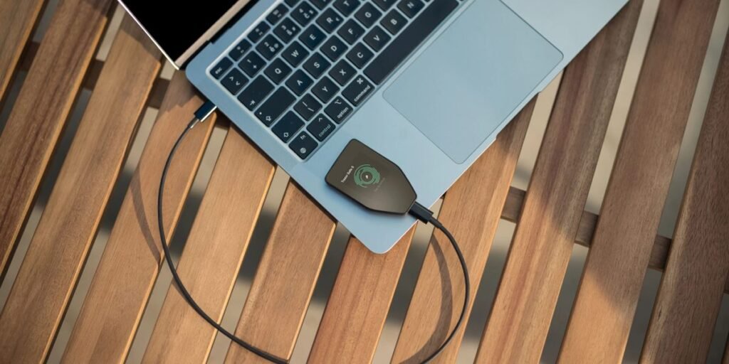 Trezor Safe 5 hardware wallet connected to a laptop for secure cryptocurrency self custody and transaction signing