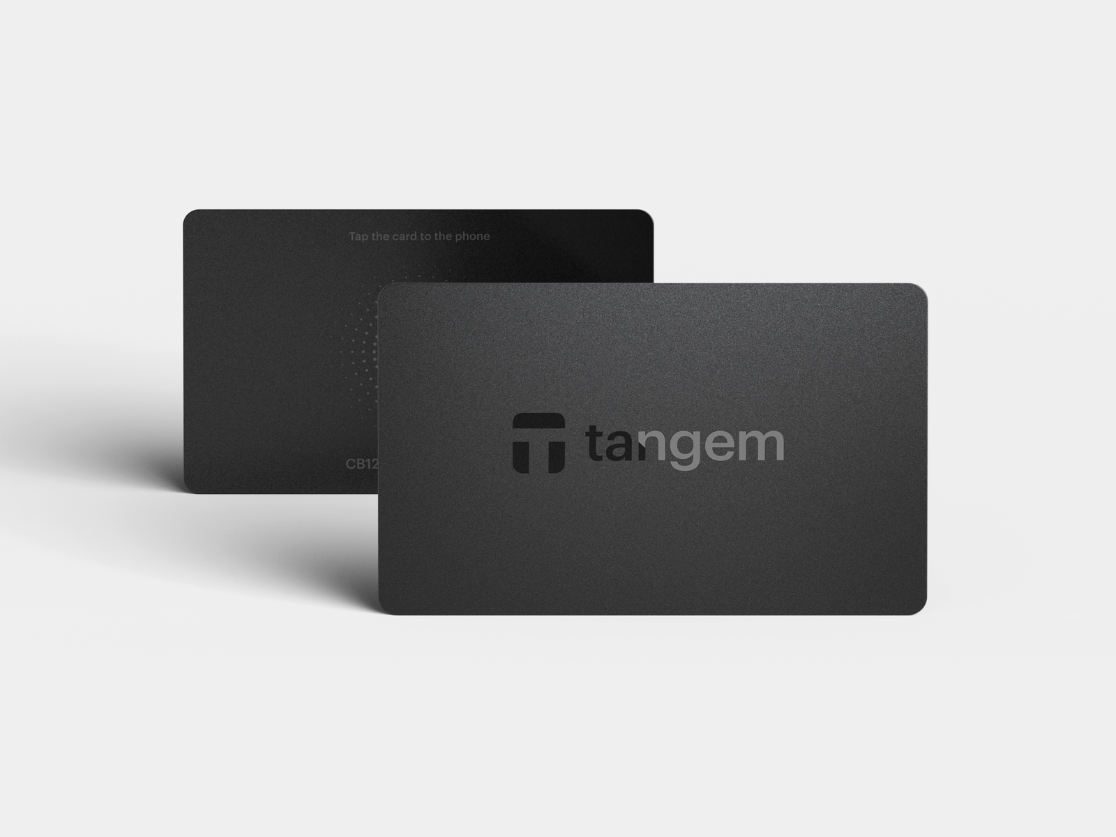 Two Tangem NFC hardware wallet cards shown at an angle on dark background