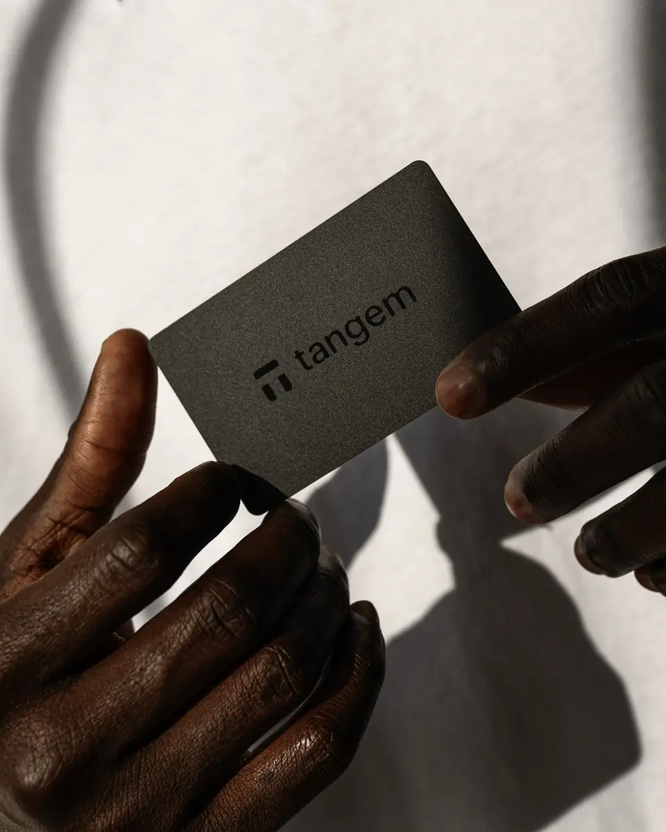 Tangem wallet card held in hand showing the physical card form factor with Tangem branding